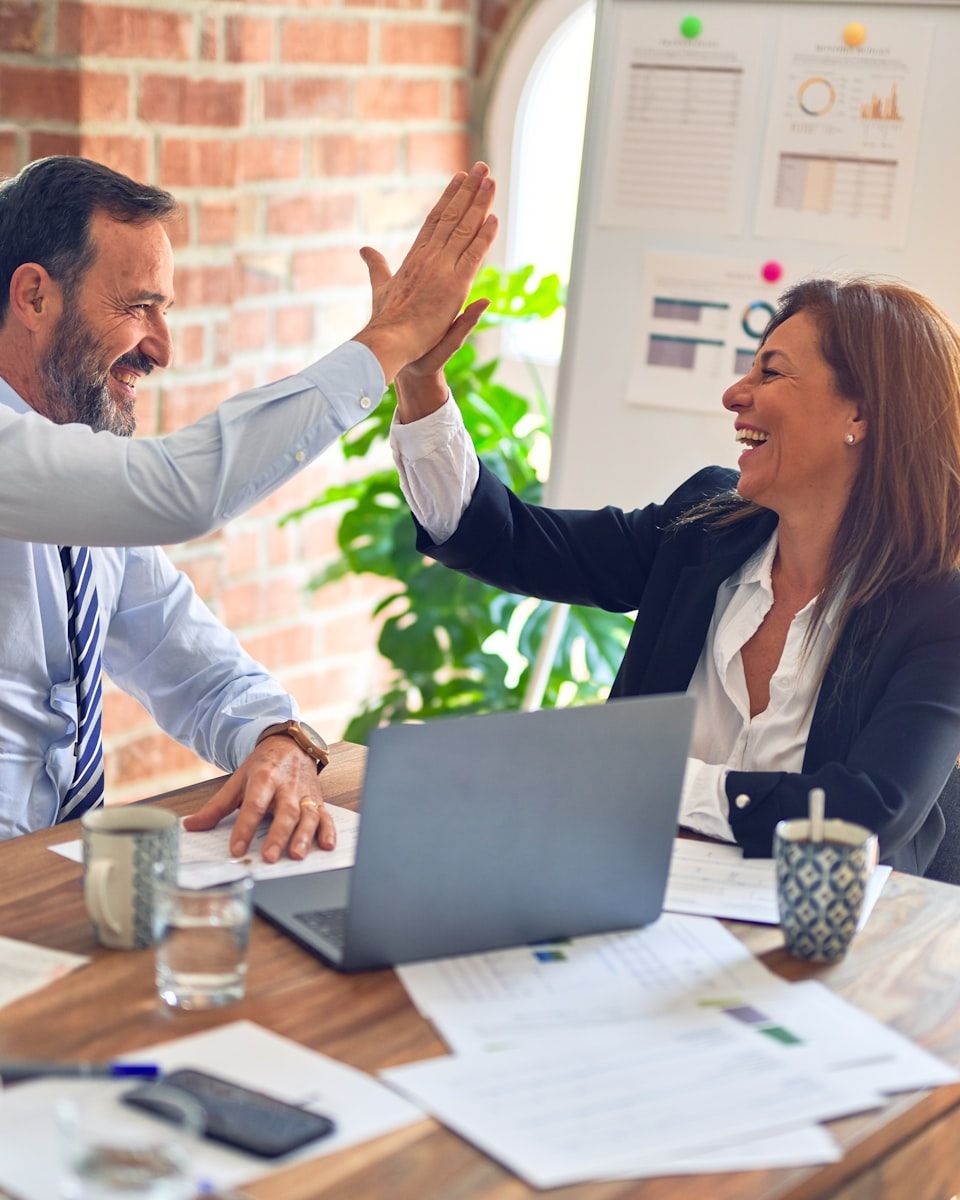 A Summit Shield advisor and a client celebrating after finding the right coverage
